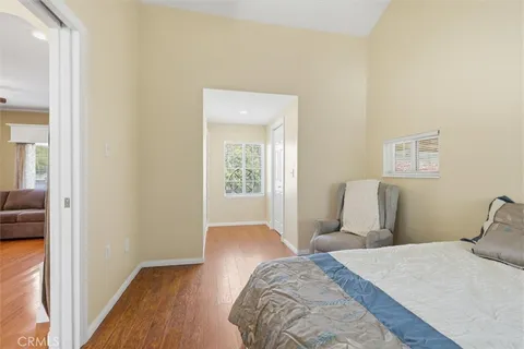 a bedroom with a bed and wooden floor