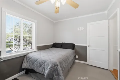 a bedroom with a large bed and a window