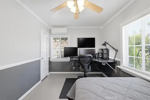 a bedroom with a bed and a large window