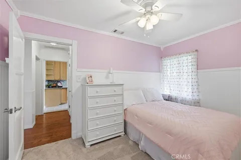 a bedroom with a bed and a ceiling fan