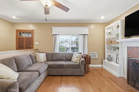 a living room with fireplace furniture and a flat screen tv