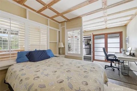 a bedroom with a large bed and a large window