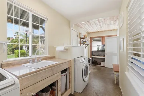 a kitchen that has a sink a stove and a refrigerator