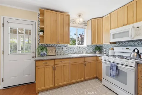 a kitchen with a sink cabinets and window