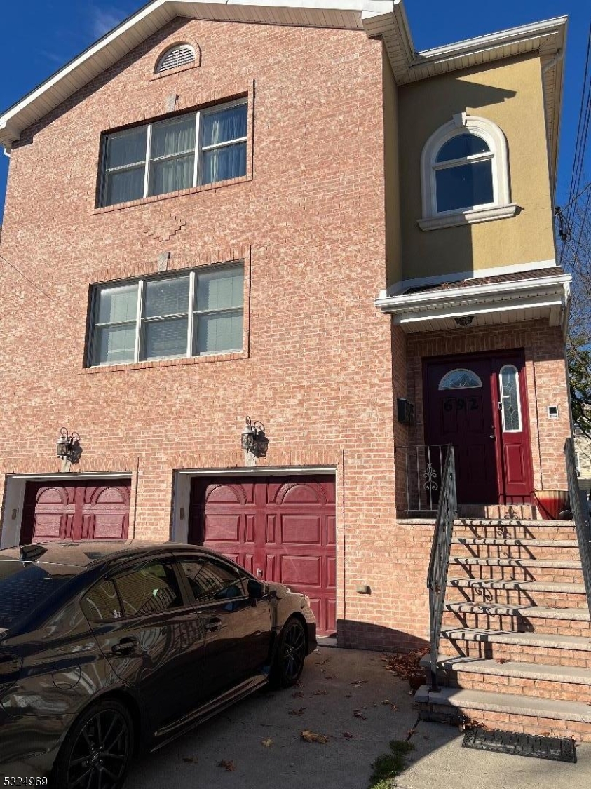 692 East 26th Street, Unit 1 Paterson, NJ 07504 - Photo 1 of 6 a view of a brick building with car parked