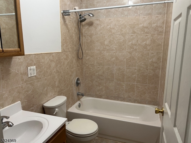 692 East 26th Street, Unit 1 Paterson, NJ 07504 - Photo 6 of 6 a bathroom with a toilet a sink and a bathtub