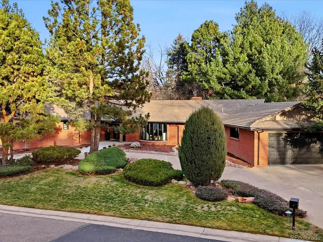 a living room with fireplace furniture and a large window
