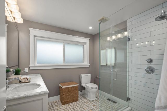 a bathroom with a toilet a sink and shower