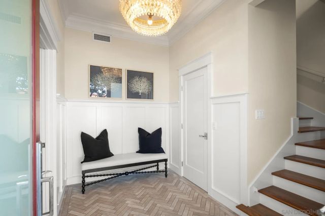 a living room with furniture and a painting on the wall