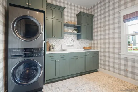 a bathroom with a sink a washer and dryer