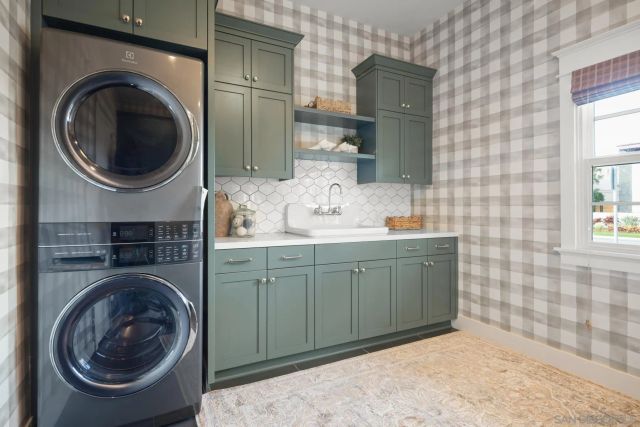 a bathroom with a sink a washer and dryer