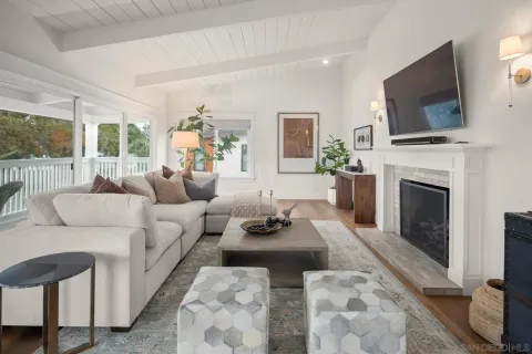a living room with furniture a fireplace and a flat screen tv