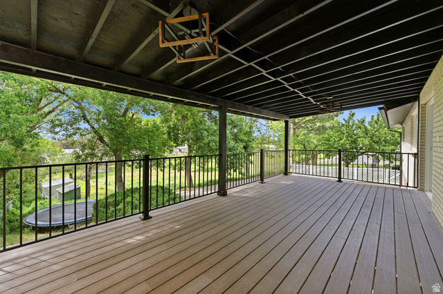 871 Bonita Way Centerville, UT 84014 - Photo 21 of 61 Spacious covered deck featuring composite decking, black metal railings, and a black painted ceiling