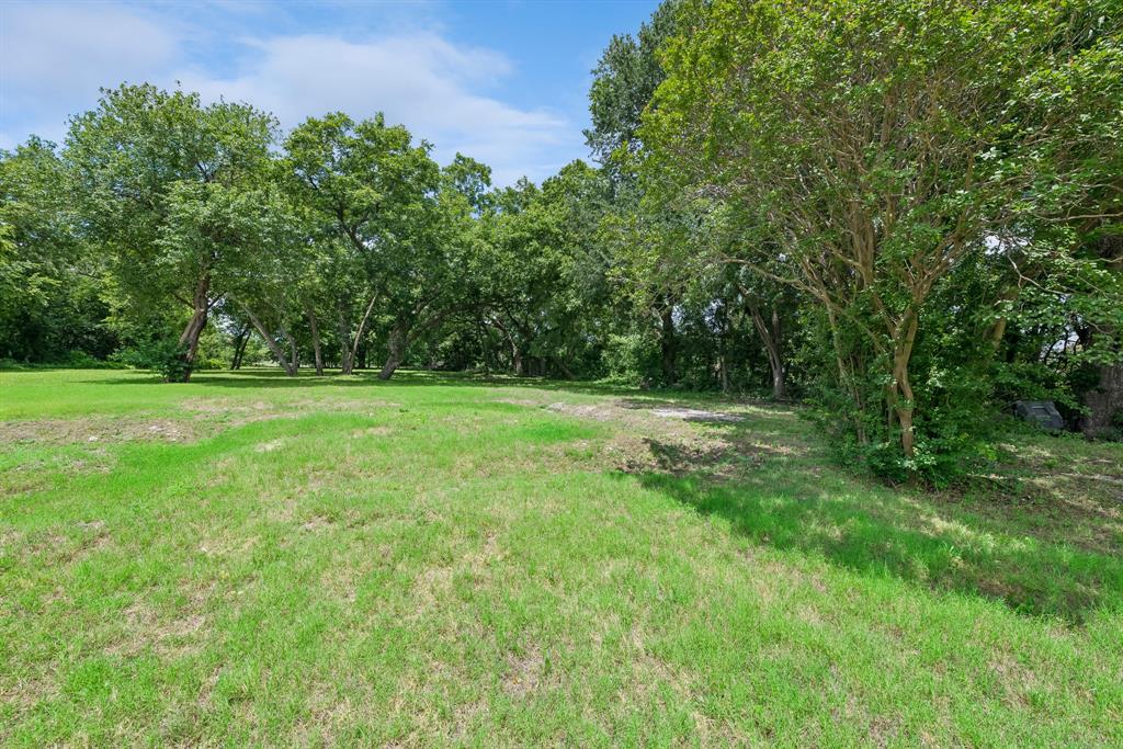 286 West Forest Grove Road Lucas, TX 75002 - Photo 15 of 23 a view of a grassy field with trees in the background