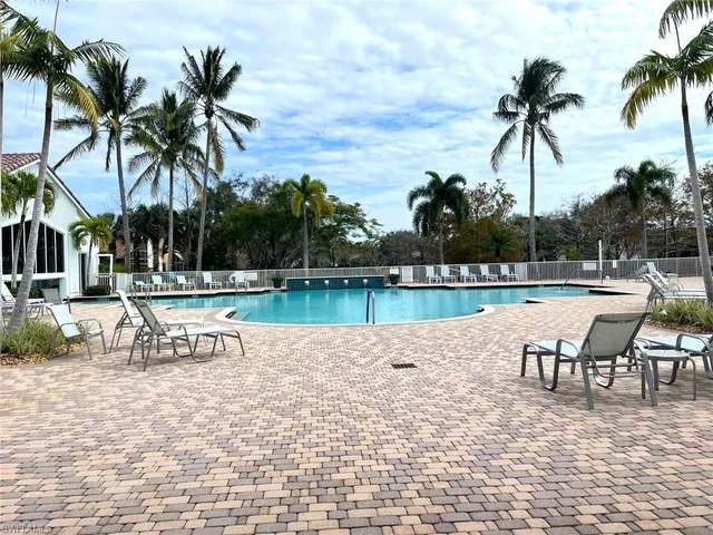 a view of a swimming pool with a table and chairs