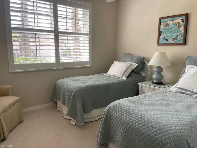 a bedroom with two beds and a couch