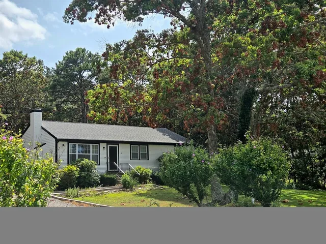 a view of a house with swimming pool and garden