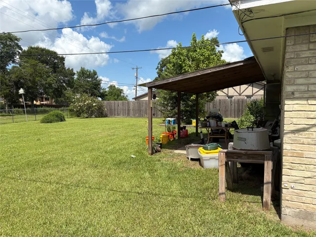 a view of a chair and table in backyard of the house