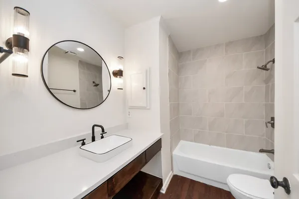 a bathroom with a sink a toilet and a mirror