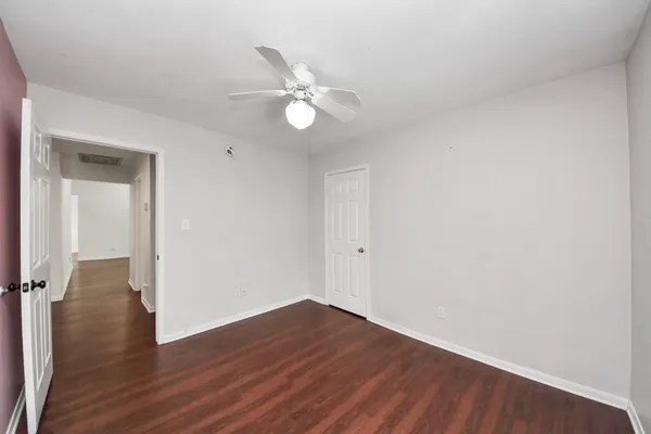 a view of a room with wooden floor