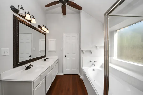 a bathroom with a double vanity sink a mirror and shower