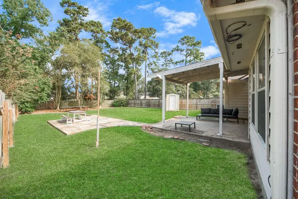 a view of a house with backyard and sitting area