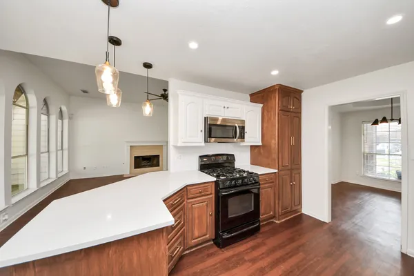a kitchen with stainless steel appliances a stove top oven a sink and a refrigerator