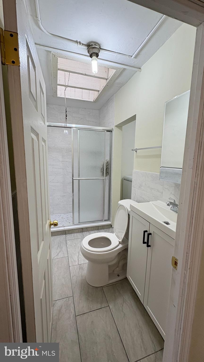 228 North 10th Street, Unit 4F Philadelphia, PA 19107 - Photo 5 of 9 a bathroom with a toilet and a shower