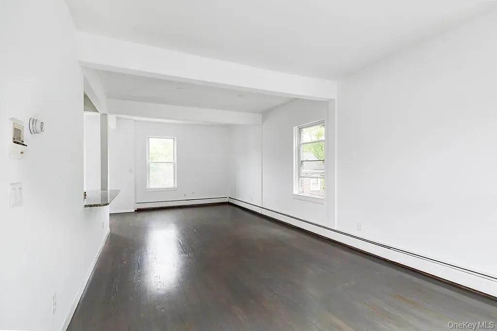 144 Union Street, Unit 4 Poughkeepsie, NY 12601 - Photo 2 of 7 an empty room with wooden floor and windows