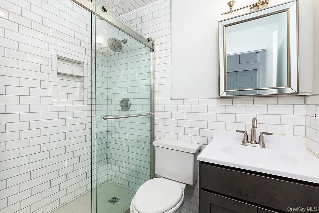 144 Union Street, Unit 4 Poughkeepsie, NY 12601 - Photo 7 of 7 a bathroom with a sink a toilet and mirror