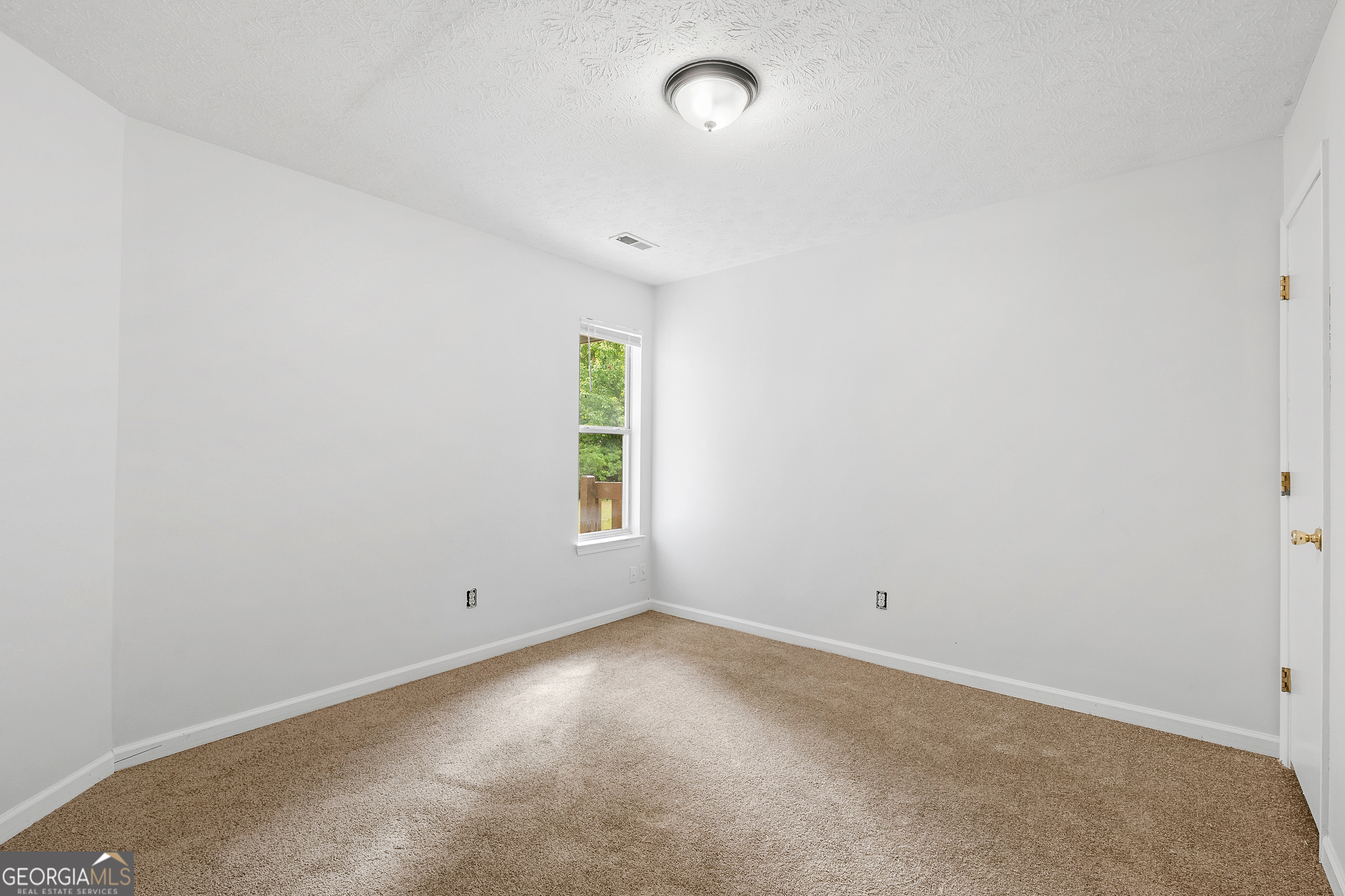 1328 Foxvale Drive Hampton, GA 30228 - Photo 22 of 27 an empty room with a window