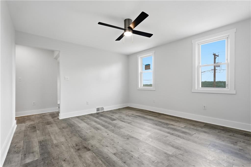 480 Songo Street Pittsburgh, PA 15227 - Photo 8 of 36 a view of empty room with wooden floor and ceiling fan