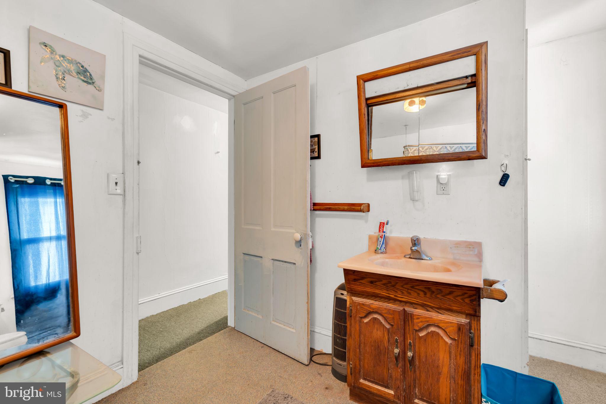 89 Chestnut Street Salem, NJ 08079 - Photo 13 of 20 a room that has a sink and a mirror in it