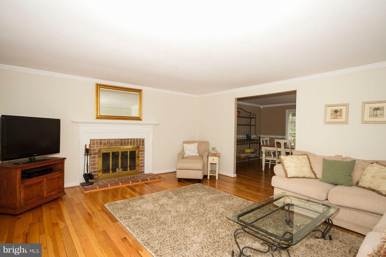 2215 Spring Lake Drive Lutherville-Timonium, MD 21093 - Photo 12 of 28 living room with hardwood flrs and fireplace
