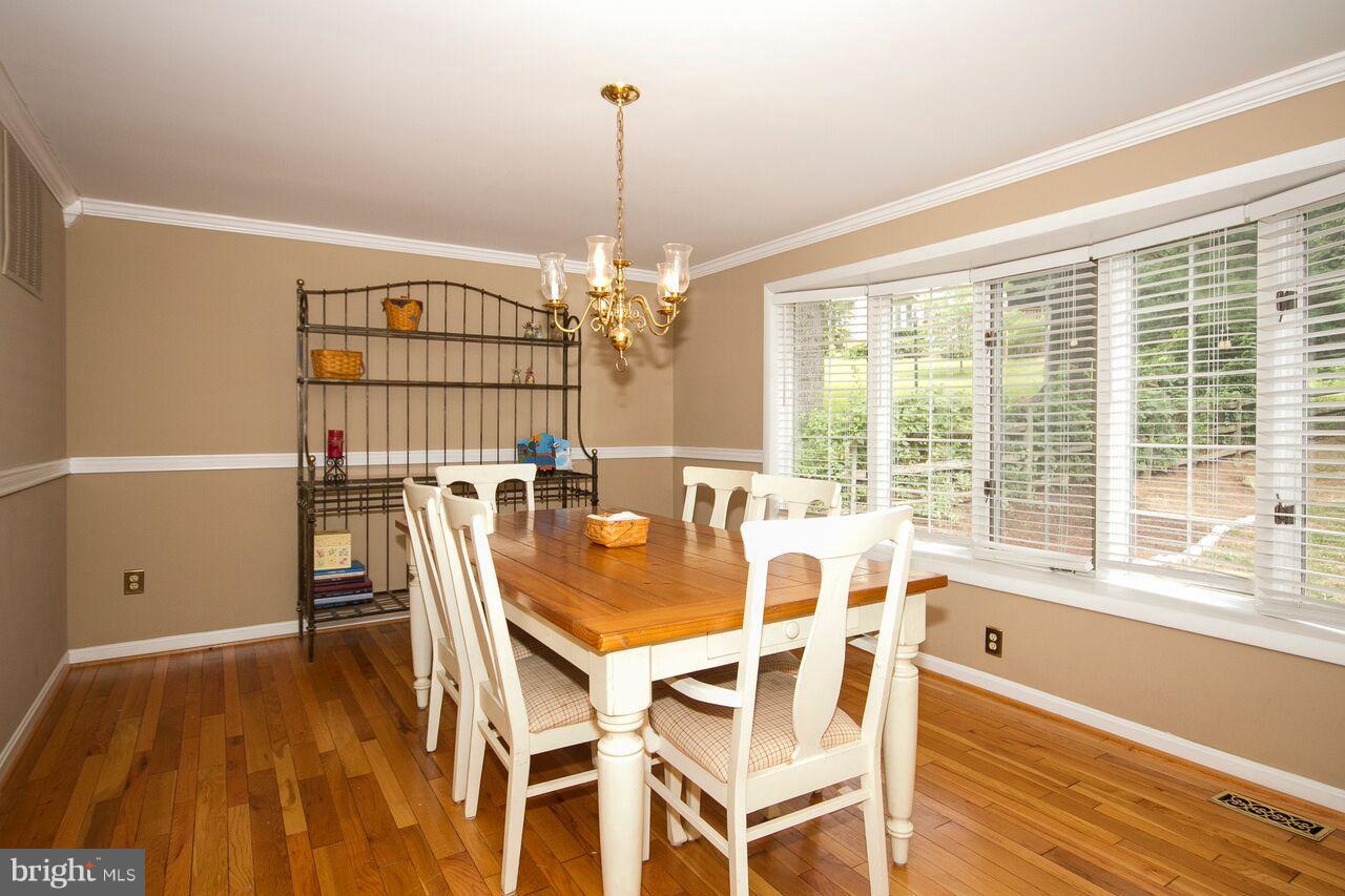 2215 Spring Lake Drive Lutherville-Timonium, MD 21093 - Photo 13 of 28 Dining Room with hardwood floors and bay window