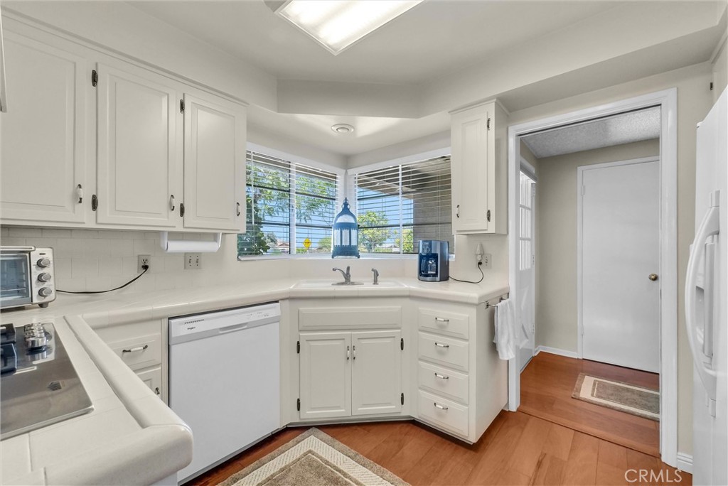 256 East Monterey Road Corona, CA 92879 - Photo 12 of 32 a kitchen with white cabinets and sink