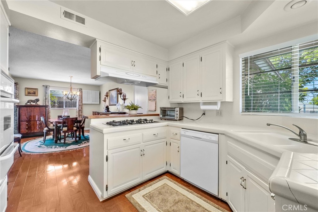 256 East Monterey Road Corona, CA 92879 - Photo 13 of 32 a kitchen with a stove a sink and a refrigerator