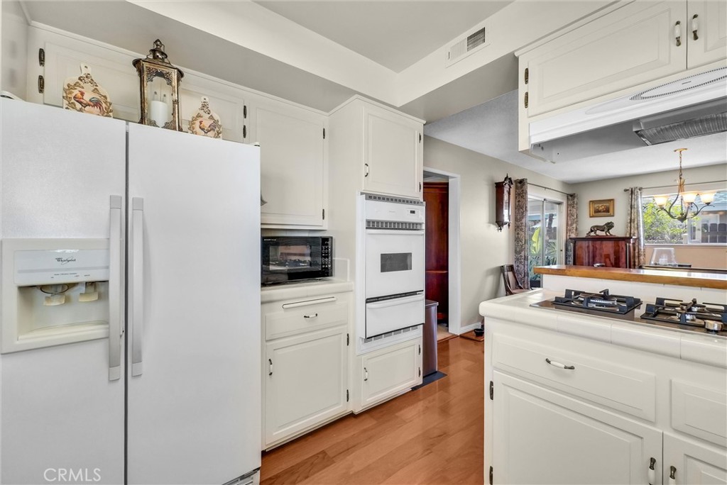 256 East Monterey Road Corona, CA 92879 - Photo 14 of 32 a kitchen with stainless steel appliances a refrigerator stove and sink