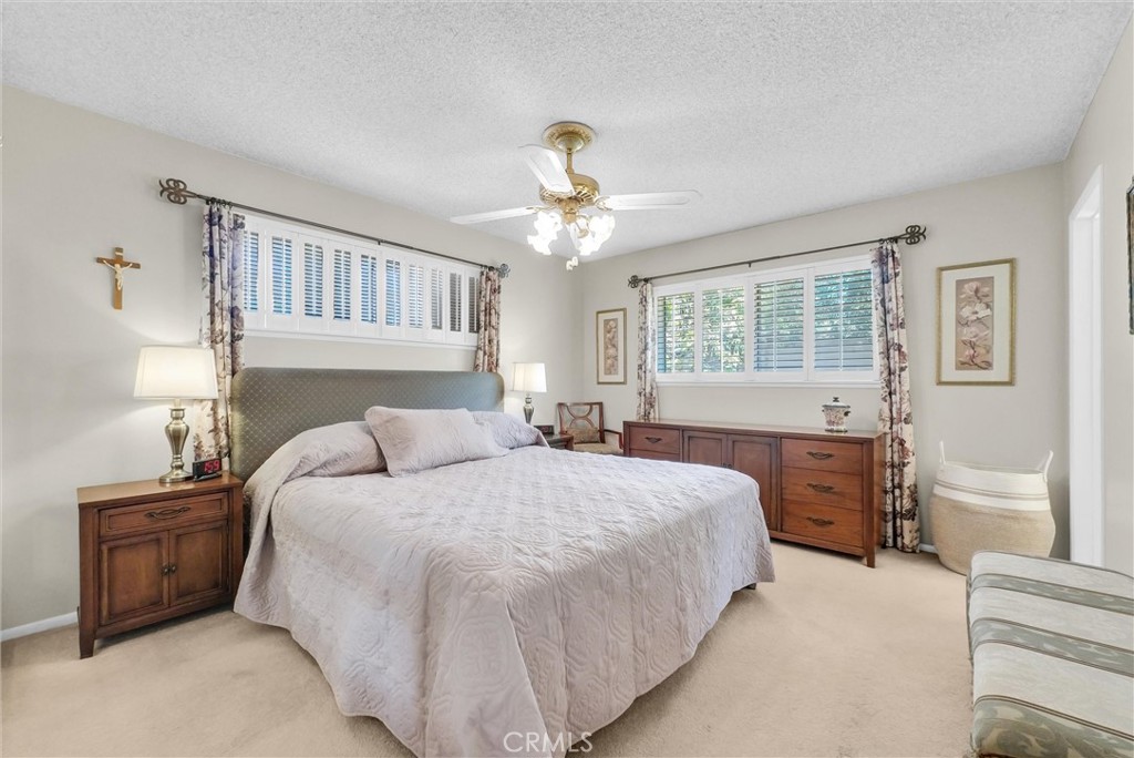 256 East Monterey Road Corona, CA 92879 - Photo 16 of 32 a bedroom with a bed and a chandelier