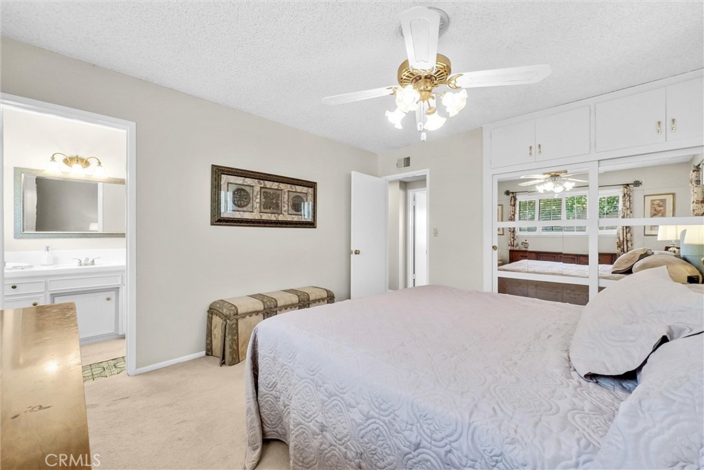 256 East Monterey Road Corona, CA 92879 - Photo 17 of 32 a bedroom with a large bed and a chandelier