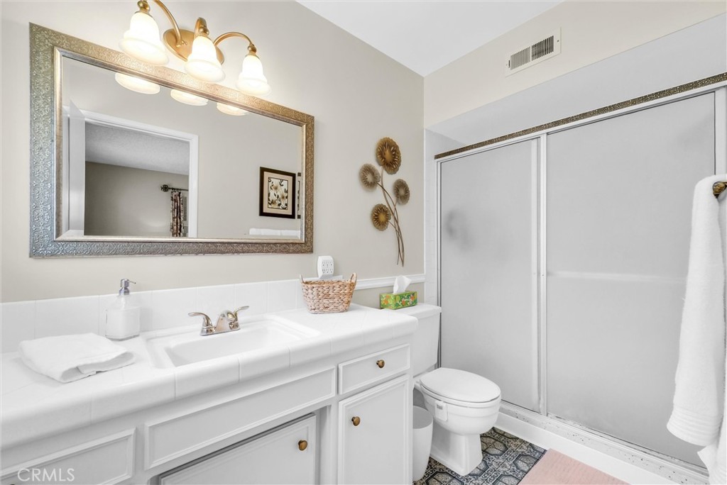 256 East Monterey Road Corona, CA 92879 - Photo 18 of 32 a bathroom with a sink a toilet and shower