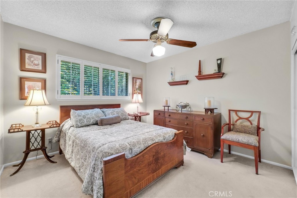 256 East Monterey Road Corona, CA 92879 - Photo 23 of 32 a bedroom with a bed and a chandelier