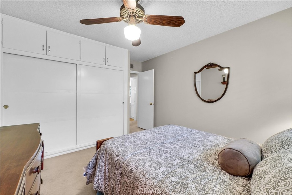 256 East Monterey Road Corona, CA 92879 - Photo 24 of 32 a bedroom with a bed and a chandelier