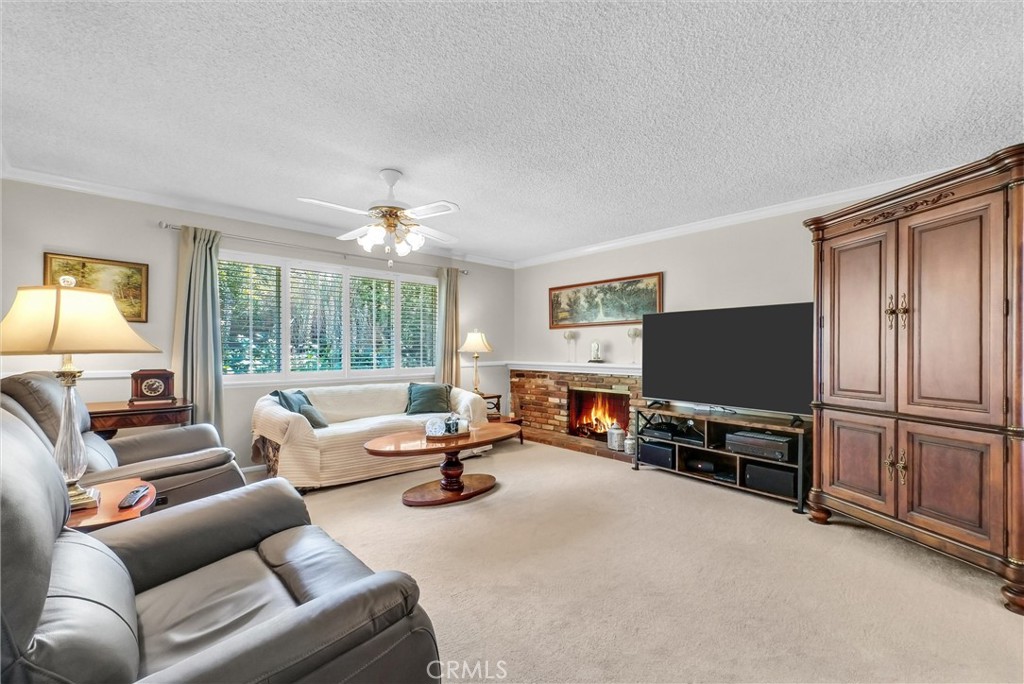 256 East Monterey Road Corona, CA 92879 - Photo 5 of 32 a living room with furniture and a flat screen tv