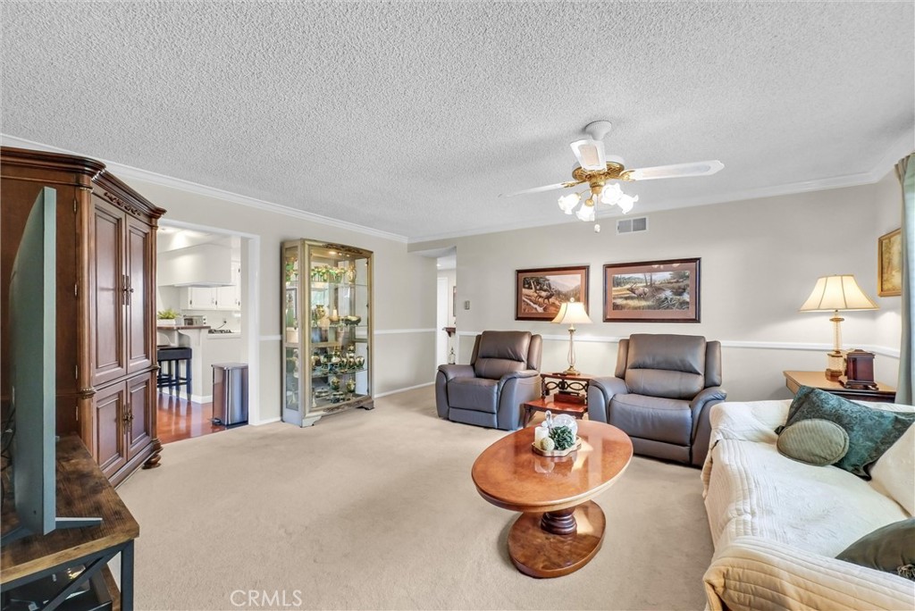 256 East Monterey Road Corona, CA 92879 - Photo 7 of 32 a living room with furniture and a chandelier