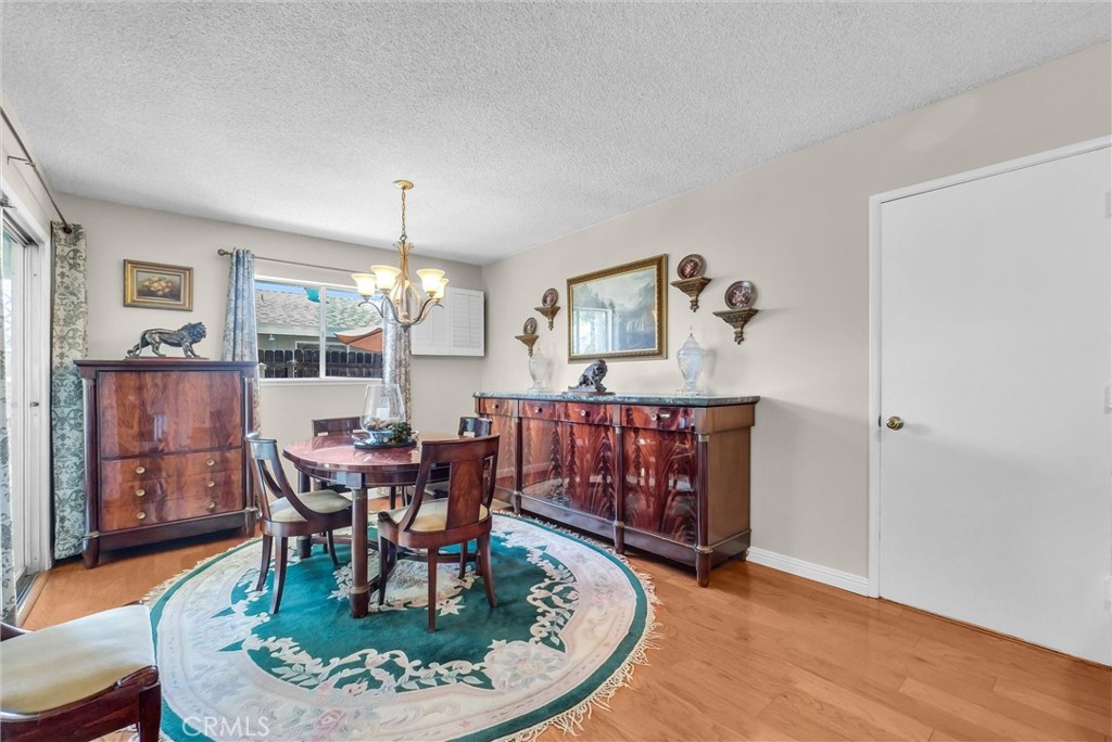 256 East Monterey Road Corona, CA 92879 - Photo 9 of 32 a view of a dining room with furniture and chandelier