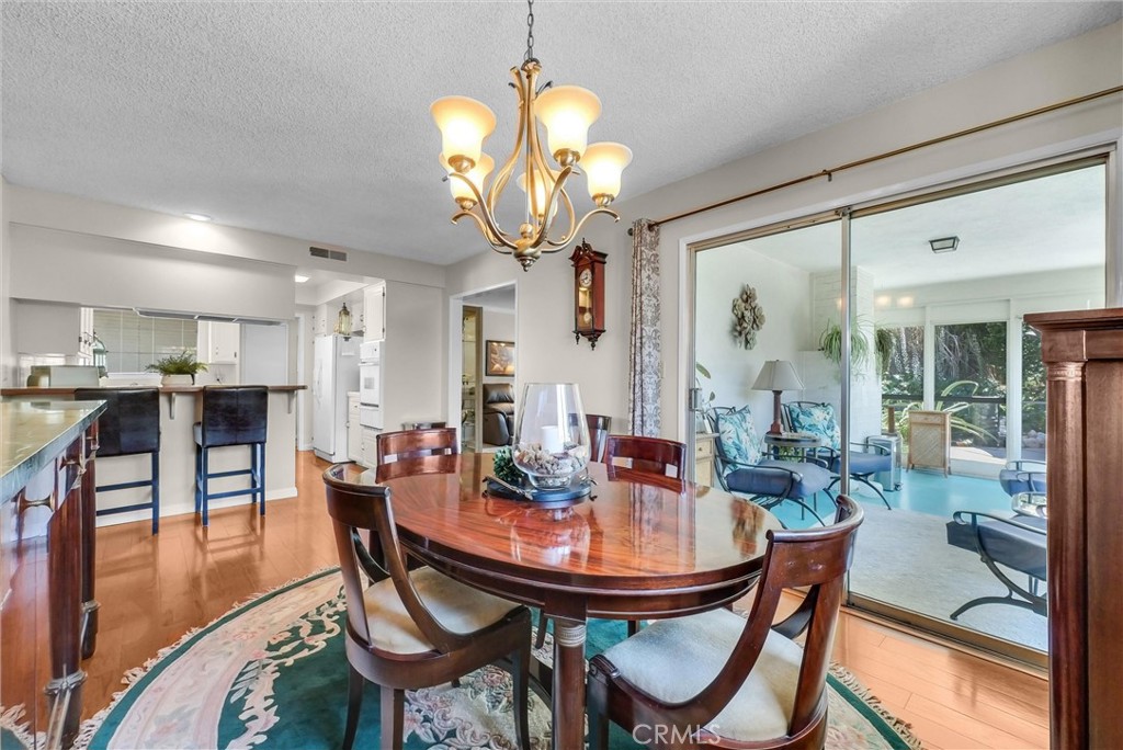 256 East Monterey Road Corona, CA 92879 - Photo 10 of 32 a view of a dining room with furniture and wooden floor