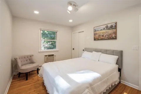 a bedroom with a bed and a couch