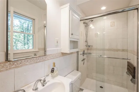 a bathroom with a shower and a sink