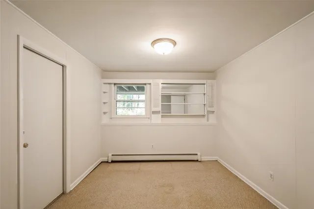 an empty room with a empty space and windows